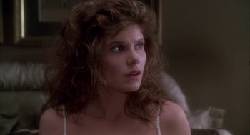 Movie still from “Raising Cain” (1992), directed by Brian De Palma – A person with long hair; Close Up shot, Over the shoulder angle