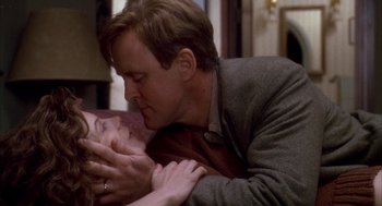 Movie still from “Raising Cain” (1992), directed by Brian De Palma – A man and a woman are kissing in a room; Close Up shot, Low angle