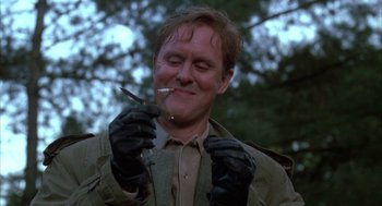 Movie still from “Raising Cain” (1992), directed by Brian De Palma – A man with a cigarette in his mouth; Close Up shot, Low angle