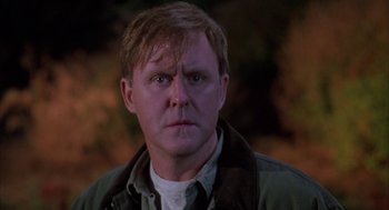 Movie still from “Raising Cain” (1992), directed by Brian De Palma – A person wearing a jacket; Close Up shot, Over the shoulder angle