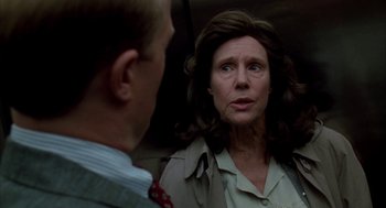 Movie still from “Raising Cain” (1992), directed by Brian De Palma – An older woman talking to a younger man; Close Up shot, Low angle