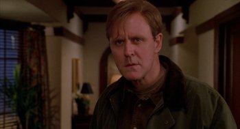 Movie still from “Raising Cain” (1992), directed by Brian De Palma – A person wearing a jacket in a room; Close Up shot, Low angle