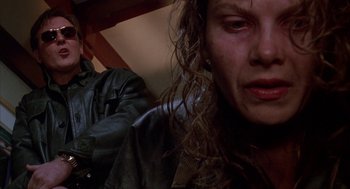 Movie still from “Raising Cain” (1992), directed by Brian De Palma – A woman in a leather jacket looking at the camera; Close Up shot, Low angle