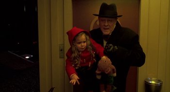 Movie still from “Raising Cain” (1992), directed by Brian De Palma – An old man and a little girl holding a teddy bear; Medium shot, Low angle