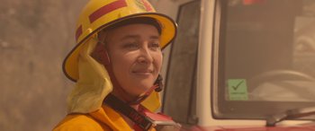 Movie still from “Rams” (2020), directed by Jeremy Sims – A woman wearing a yellow and red helmet; Close Up shot, Over the shoulder angle