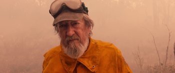 An older man with a beard wearing a hat