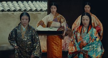 Movie still from “Ran” (1985), directed by Akira Kurosawa – A group of women dressed in traditional japanese clothing; Medium shot, Low angle