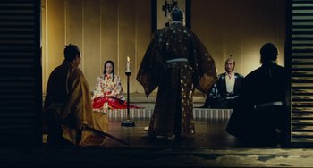 Movie still from “Ran” (1985), directed by Akira Kurosawa – A group of people dressed in traditional japanese garb; Wide shot, High angle