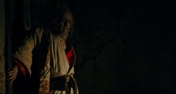 Movie still from “Ran” (1985), directed by Akira Kurosawa – An old man with a long white beard wearing a robe; Medium shot, Low angle