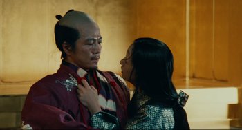 Movie still from “Ran” (1985), directed by Akira Kurosawa – A man and a woman in traditional japanese garb; Medium shot, Low angle