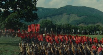Movie still from “Ran” (1985), directed by Akira Kurosawa – A lot of red flags in a field; Extreme Wide shot, High angle