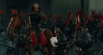 Movie still from “Ran” (1985), directed by Akira Kurosawa – A group of people dressed in samurai garb; Wide shot, High angle