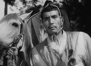 Movie still from “Rashomon” (1950), directed by Akira Kurosawa – An old photo of a man and a horse; Close Up shot, Low angle