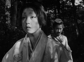 Movie still from “Rashomon” (1950), directed by Akira Kurosawa – A man and a woman in traditional japanese garb; Close Up shot, Low angle