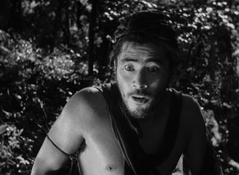 Movie still from “Rashomon” (1950), directed by Akira Kurosawa – Black and white photograph of a man with a beard; Close Up shot, Low angle