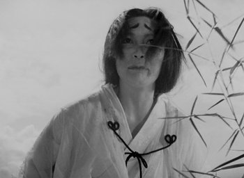 Movie still from “Rashomon” (1950), directed by Akira Kurosawa – A black and white photo of a woman wearing a kimono; Close Up shot, Low angle