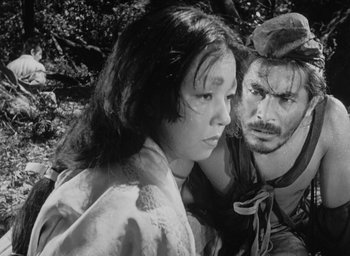 Movie still from “Rashomon” (1950), directed by Akira Kurosawa – A man and a woman are looking at each other; Close Up shot, Low angle