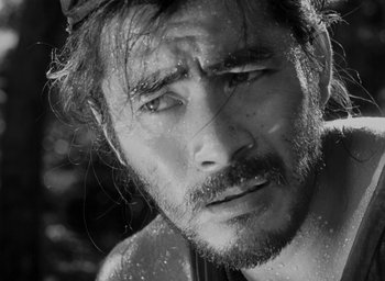 Movie still from “Rashomon” (1950), directed by Akira Kurosawa – Black and white photograph of a man with wet hair; Extreme Close Up shot, Low angle