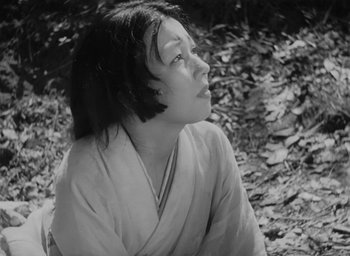Movie still from “Rashomon” (1950), directed by Akira Kurosawa – Black and white photograph of a woman in a kimono; Close Up shot, Low angle