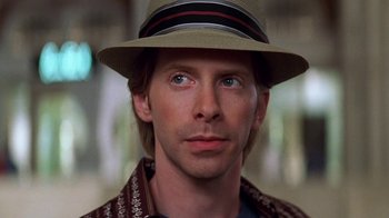 Movie still from “Rat Race” (2001), directed by Jerry Zucker – A person wearing a hat; Close Up shot, Over the shoulder angle