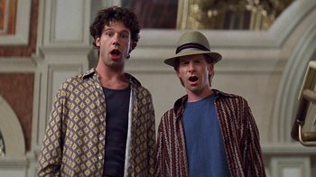 Movie still from “Rat Race” (2001), directed by Jerry Zucker – A couple of men standing next to each other; Close Up shot, Low angle