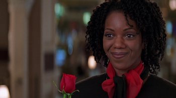 Movie still from “Rat Race” (2001), directed by Jerry Zucker – A woman holding a red rose in her hand; Close Up shot, Over the shoulder angle