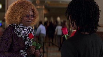 Movie still from “Rat Race” (2001), directed by Jerry Zucker – A woman holding a rose in her hand and another woman standing next to her; Close Up shot, Over the shoulder angle