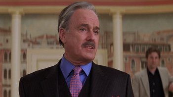 Movie still from “Rat Race” (2001), directed by Jerry Zucker – An older man wearing a suit and tie; Close Up shot, Low angle