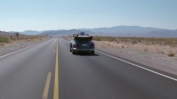 Movie still from “Rat Race” (2001), directed by Jerry Zucker – A car driving down a road in the middle of the desert; Extreme Wide shot, High angle