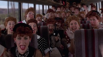 Movie still from “Rat Race” (2001), directed by Jerry Zucker – A bunch of people that are sitting on a bus; Wide shot, High angle