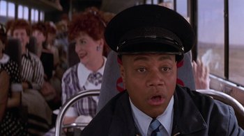Movie still from “Rat Race” (2001), directed by Jerry Zucker – A man in a uniform and a woman on a bus; Close Up shot, High angle