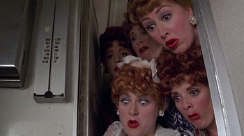 Movie still from “Rat Race” (2001), directed by Jerry Zucker – A group of people with their faces in the air; Close Up shot, Overhead angle