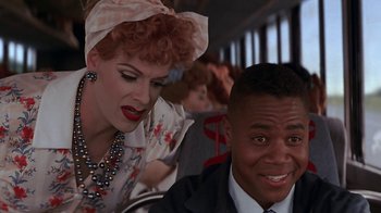 Movie still from “Rat Race” (2001), directed by Jerry Zucker – A man and a woman sitting next to each other on a bus; Close Up shot, Over the shoulder angle