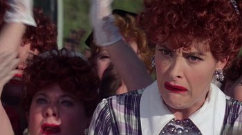 Movie still from “Rat Race” (2001), directed by Jerry Zucker – A group of people dressed up as lucille ball; Close Up shot, Over the shoulder angle