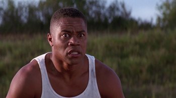 Movie still from “Rat Race” (2001), directed by Jerry Zucker – A person wearing a tank top; Close Up shot, Low angle