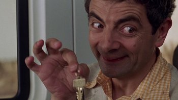 Movie still from “Rat Race” (2001), directed by Jerry Zucker – A person holding a key; Close Up shot, High angle