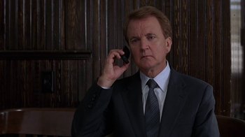 Movie still from “Rat Race” (2001), directed by Jerry Zucker – A man wearing a suit and tie holding a cell phone; Close Up shot, Low angle