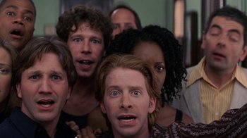 Movie still from “Rat Race” (2001), directed by Jerry Zucker – A group of people standing next to each other; Close Up shot, Low angle