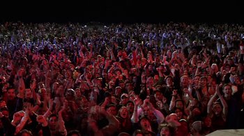 Movie still from “Rat Race” (2001), directed by Jerry Zucker – A crowd of people in a stadium at night; Extreme Wide shot, High angle