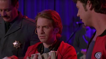 Movie still from “Rat Race” (2001), directed by Jerry Zucker – A man in a red jacket is holding a bunch of money; Close Up shot, Over the shoulder angle