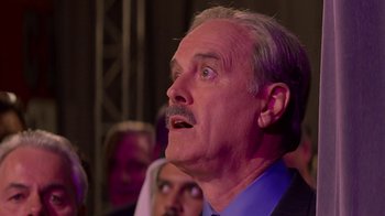 Movie still from “Rat Race” (2001), directed by Jerry Zucker – An older man in a blue shirt and tie; Close Up shot, Low angle