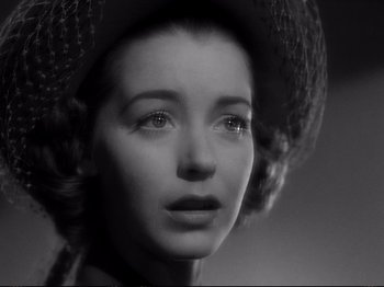 Movie still from “Raw Deal” (1948), directed by Anthony Mann – A black and white photo of a woman wearing a hat; Close Up shot, Low angle