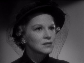 Movie still from “Raw Deal” (1948), directed by Anthony Mann – A black and white photo of a woman wearing a hat; Close Up shot, Low angle