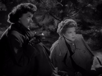 Movie still from “Raw Deal” (1948), directed by Anthony Mann – A couple of women sitting next to each other on a bench; Medium shot, High angle