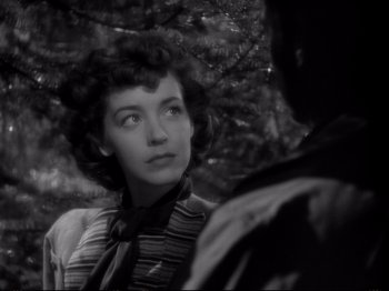 Movie still from “Raw Deal” (1948), directed by Anthony Mann – A black - and - white photo of a woman looking at a man; Close Up shot, Over the shoulder angle