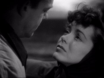 Movie still from “Raw Deal” (1948), directed by Anthony Mann – A man and a woman looking at one another; Close Up shot, Over the shoulder angle