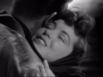Movie still from “Raw Deal” (1948), directed by Anthony Mann – An old black and white photo of a woman laying on top of a man; Close Up shot, Over the shoulder angle