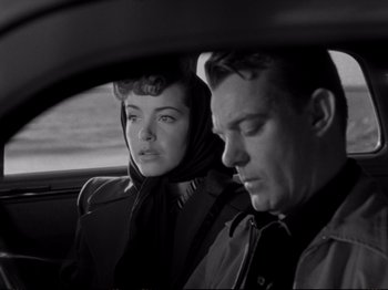 Movie still from “Raw Deal” (1948), directed by Anthony Mann – A man and a woman sitting in the back of a car; Close Up shot, Over the shoulder angle