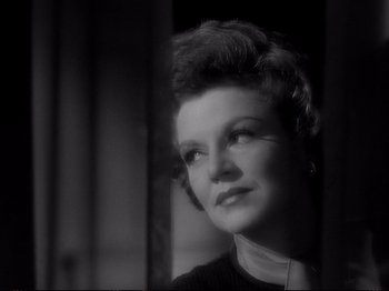 Movie still from “Raw Deal” (1948), directed by Anthony Mann – An old photo of an older woman looking at the camera; Close Up shot, Low angle