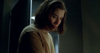 Movie still from “Read My Lips” (2001), directed by Jacques Audiard – A young woman in a sweater looking down at the floor; Close Up shot, Low angle